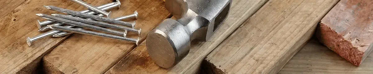 Hammer and nails on hardwood flooring boards in South Bend, IN