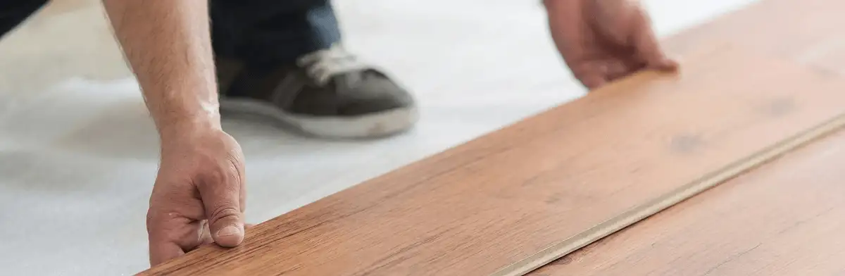A professional installing laminate flooring in South Bend, IN